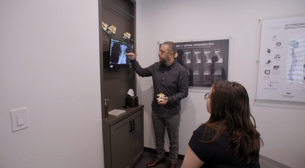 Doctor reviewing digital X-ray with patient
