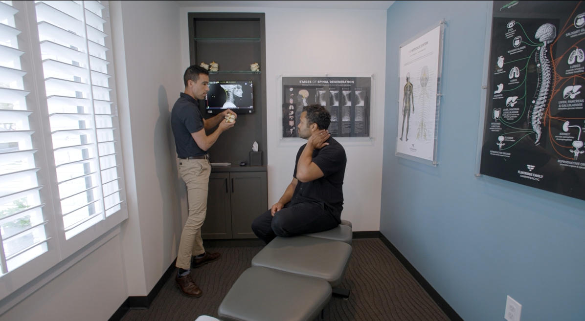Dr. Zimmerman explaining a patient's spinal X-ray during a one-on-one consultation in our La Cañada Flintridge office